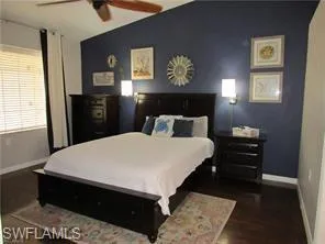 Bedroom featuring dark hardwood / wood-style flooring and ceiling fan