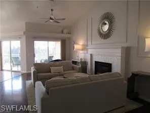 Living room with hardwood / wood-style floors and ceiling fan