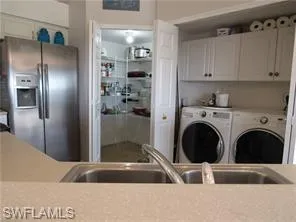 Laundry room with cabinets and washer and dryer