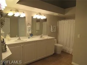 Bathroom featuring a notable chandelier and double vanity