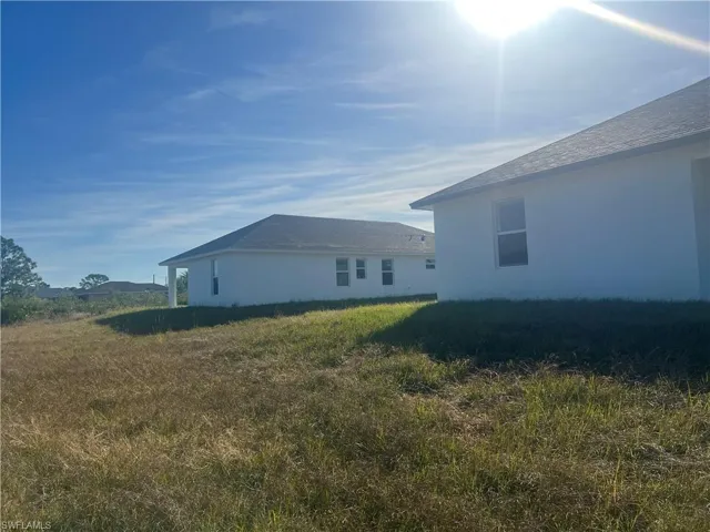 View of side of property featuring a yard