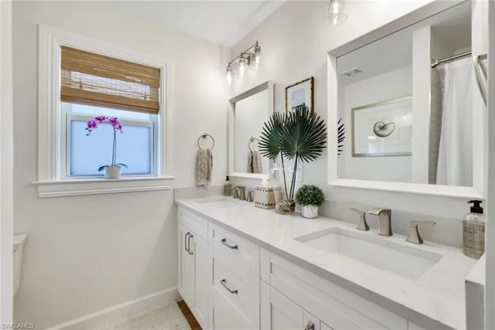 Full bathroom featuring double vanity, a sink, baseboards, and visible vents