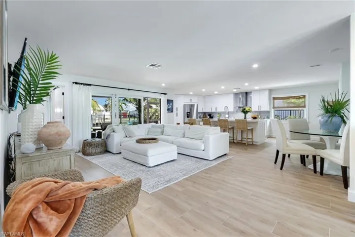 Living room featuring recessed lighting, light wood finished floors, and visible vents