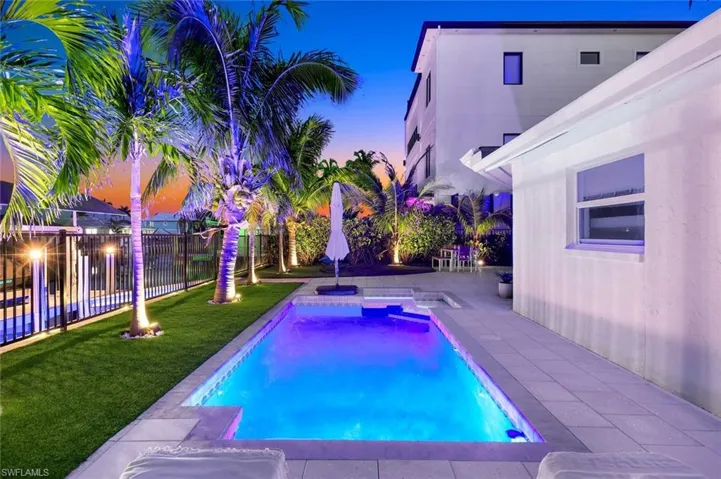 View of swimming pool featuring a fenced backyard, a fenced in pool, a lawn, and a patio area