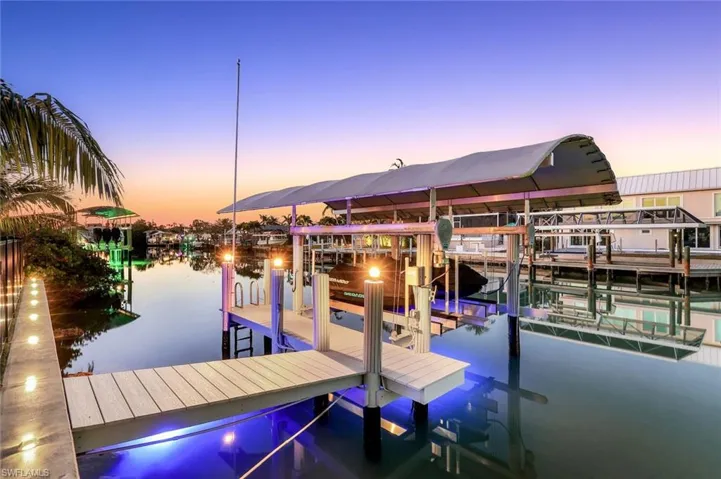 Dock area with boat lift and a water view
