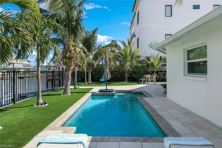 View of swimming pool with fence, a fenced in pool, a yard, and a patio area