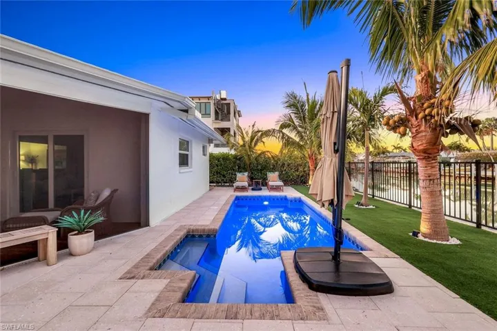 View of swimming pool with a fenced in pool, a lawn, fence, and a patio