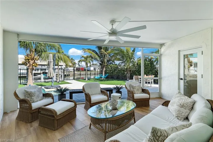 View of patio / terrace featuring an outdoor living space, fence, and a ceiling fan