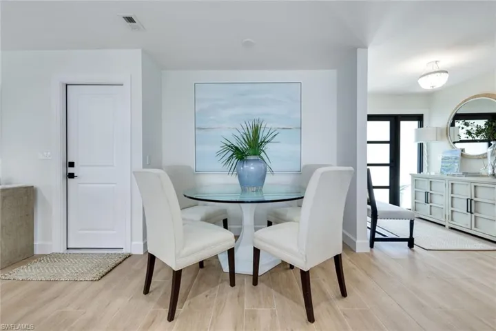 Dining space featuring baseboards, visible vents, and wood finished floors