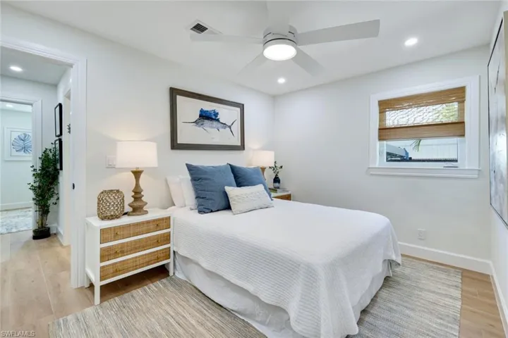 Bedroom with a ceiling fan, light wood-style flooring, baseboards, visible vents, and recessed lighting
