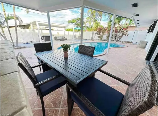 Fenced backyard featuring a patio area and outdoor dining area
