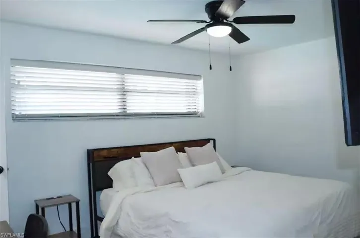 Bedroom with multiple windows and a ceiling fan