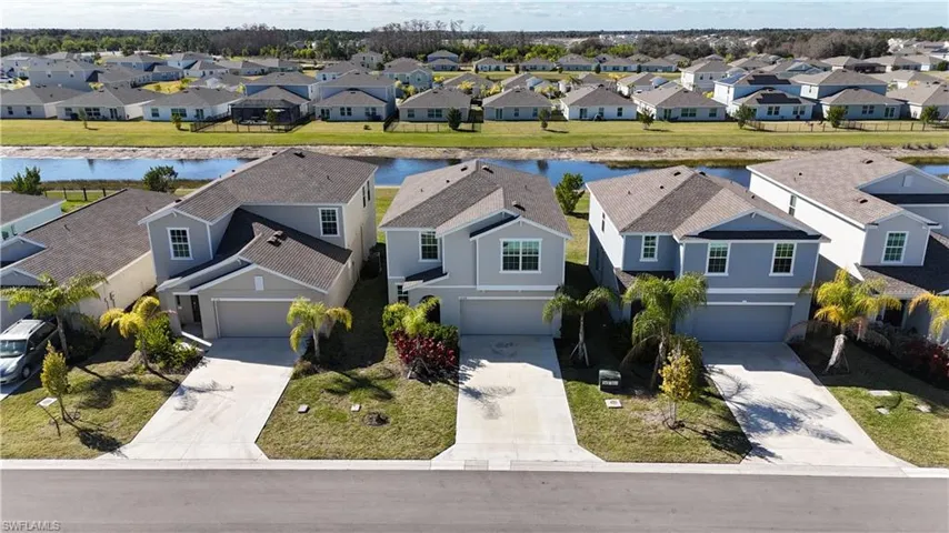 Aerial perspective of suburban area with a nearby body of water