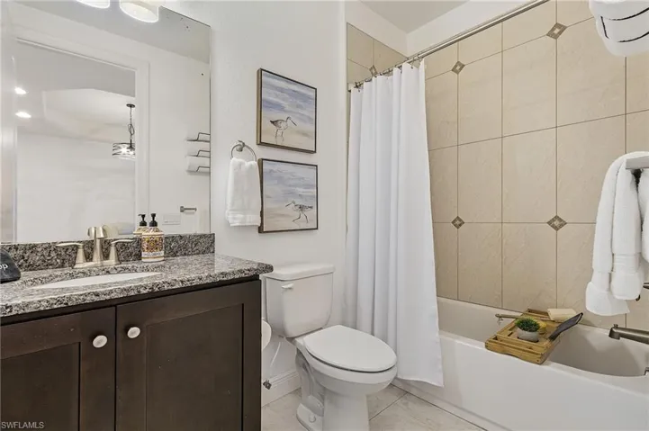 Full bathroom featuring vanity, shower / tub combo