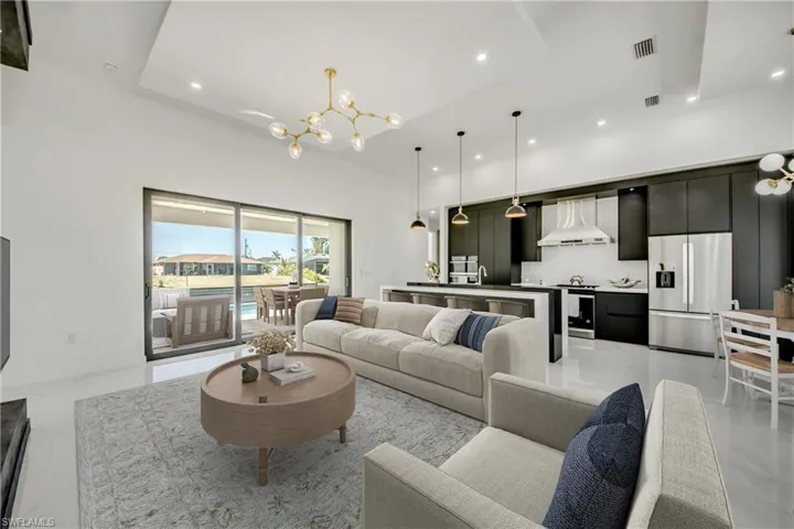 Virtually staged Living room with a chandelier, sink, and a high ceiling