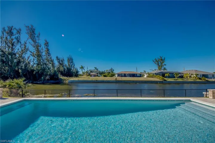 View of pool with a water view