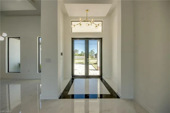 Foyer with a chandelier and french doors