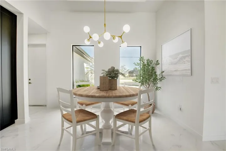 Virtually staged Dining space featuring a notable chandelier