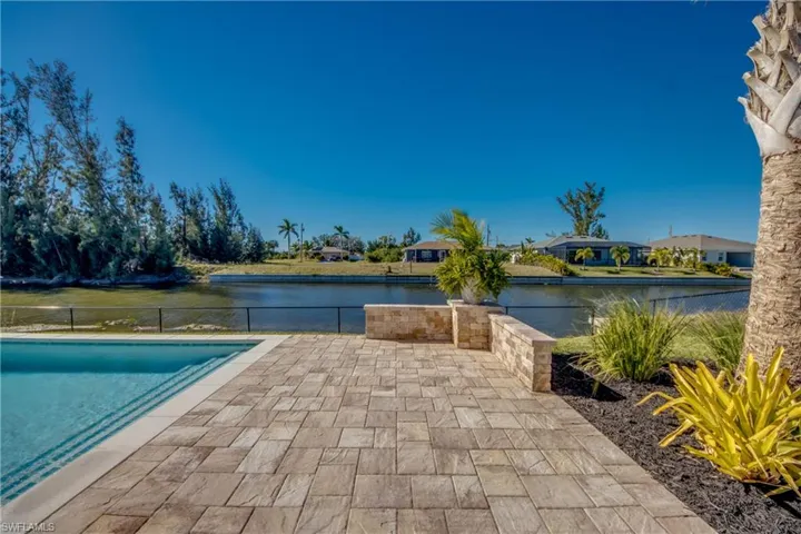 View of swimming pool featuring a patio and a water view