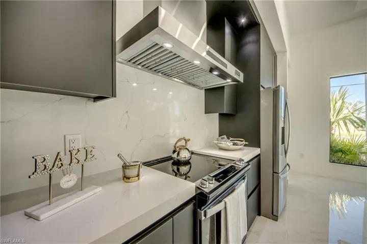Kitchen featuring  range hood and appliances with stainless steel finishes