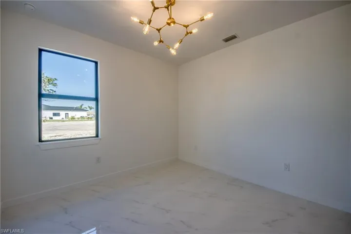 Empty room with a notable chandelier