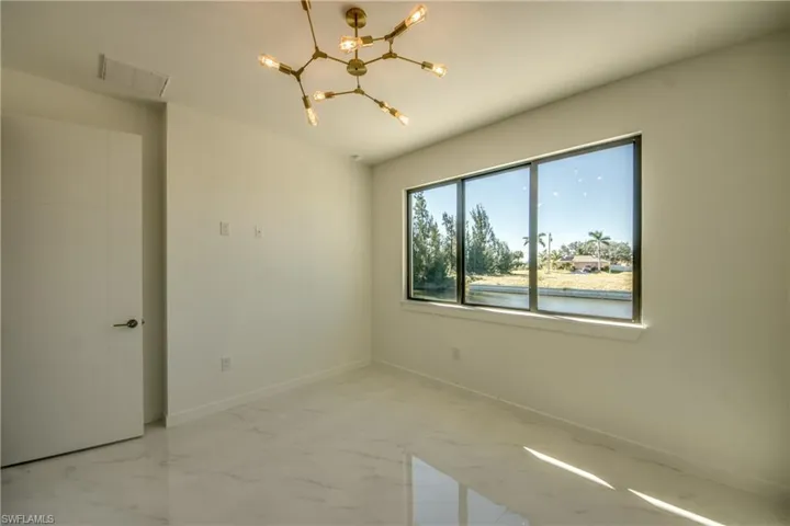 Spare room featuring a chandelier