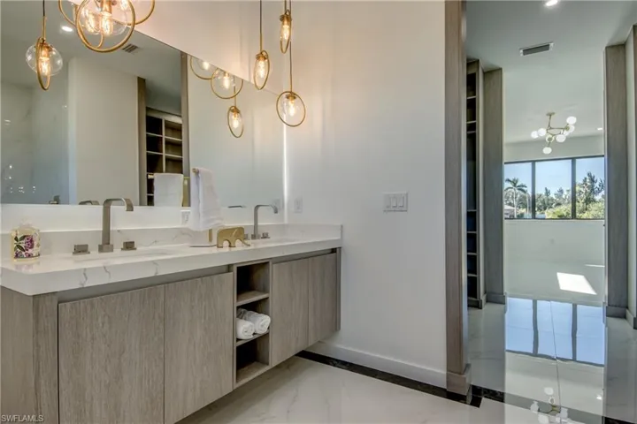 Bathroom featuring a chandelier and vanity