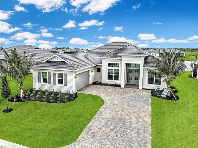 Ranch-style home featuring a garage and a front yard