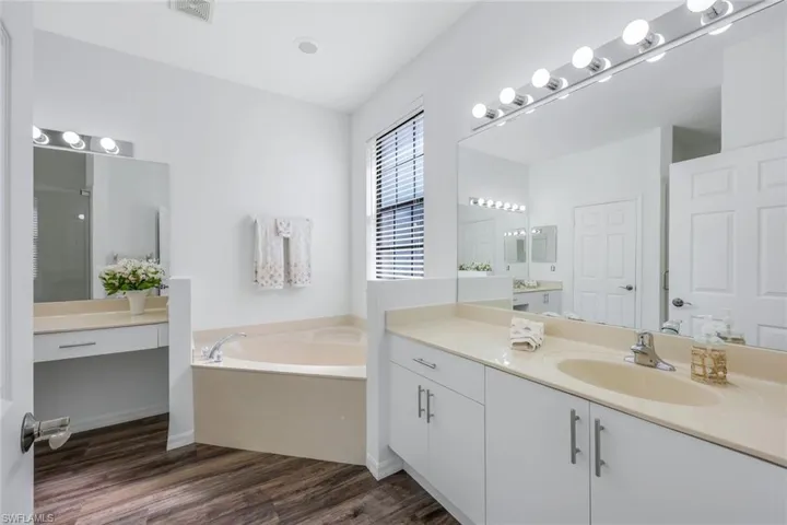 Primary bath has both a tub and shower. Two vanity areas and a private water closet.