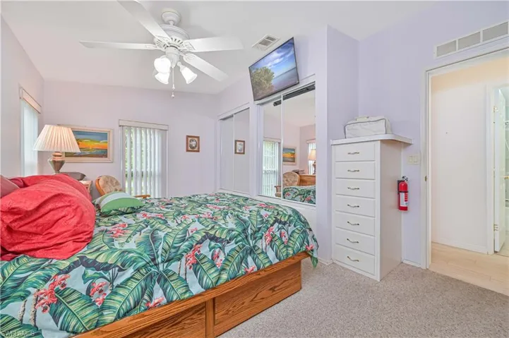 Bedroom featuring vaulted ceiling, carpet, a closet, and ceiling fan