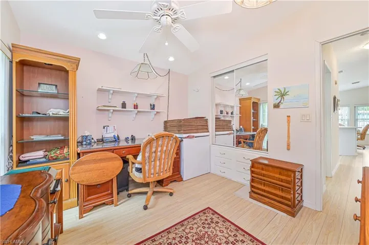 Office area featuring vaulted ceiling, ceiling fan, and light wood-type flooring