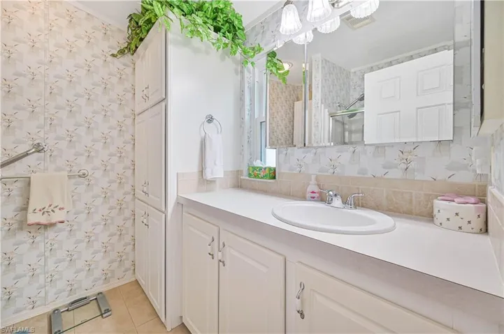 Bathroom with vanity, backsplash, and tile patterned floors