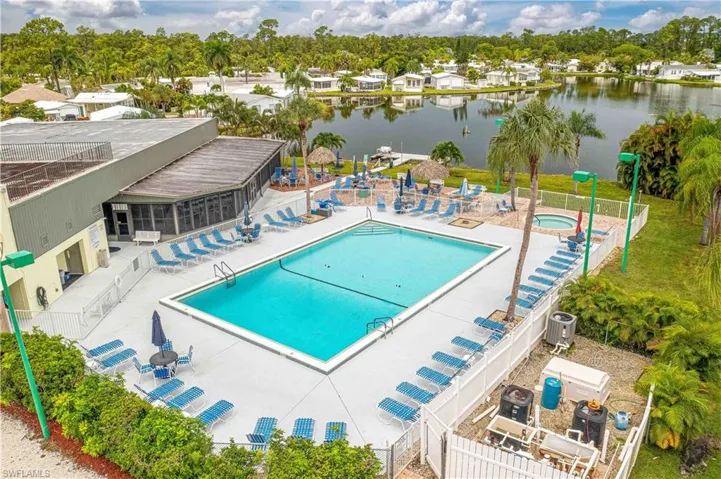 View of pool with a patio, a water view, and central air condition unit