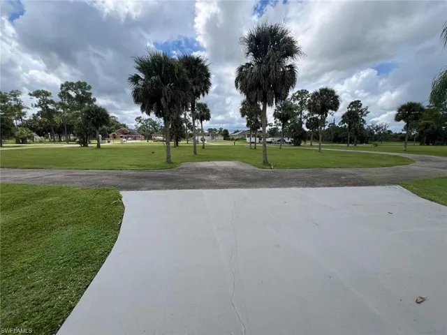 View of home's community with a lawn and driveway