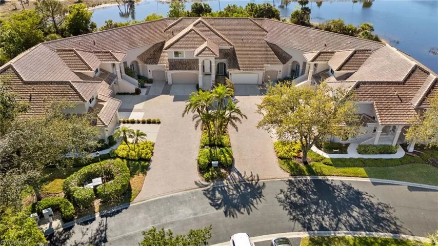 Aerial view of property and surrounding area featuring a nearby body of water