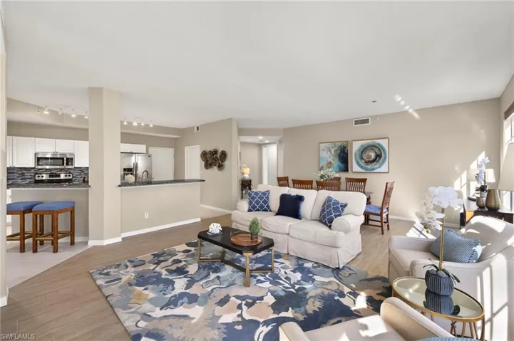 Living area featuring track lighting, light wood-type flooring, and baseboards