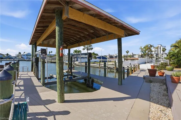 Private boat dock with covered boat lift and composite decking - Virtually Edited Image