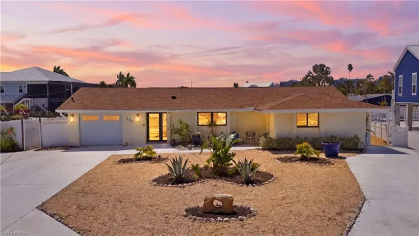 Single-story residence featuring a brown shingle roof and a cream-colored exterior - Virtually Edited Image
