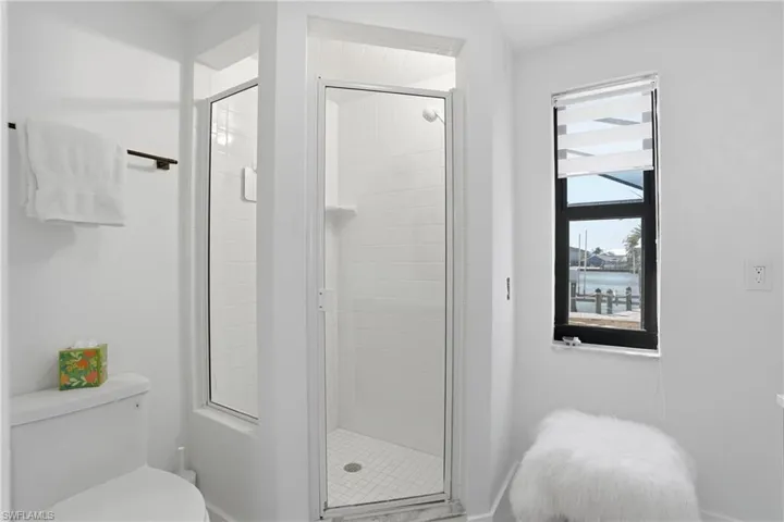 Shower stall with glass enclosure and white subway tile surround - Virtually Edited Image