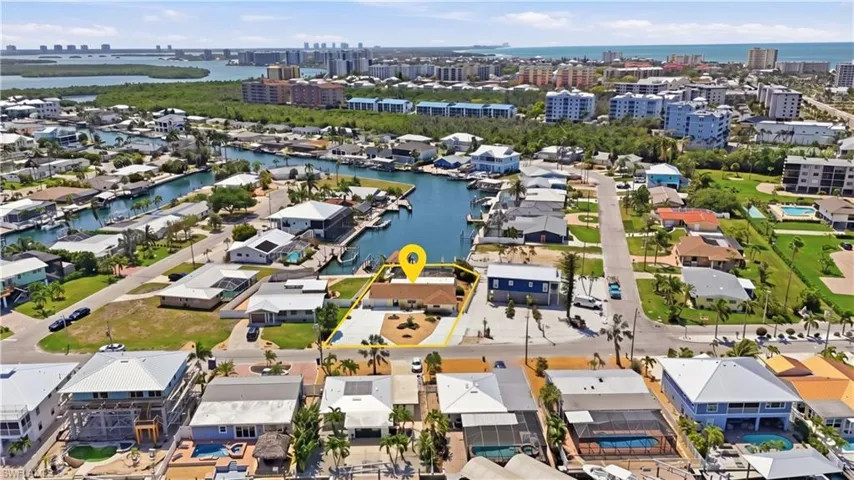 Waterfront property with direct canal access, featuring a private boat dock - Virtually Edited Image