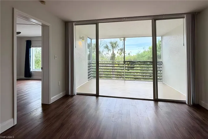 Doorway with wood-type flooring and baseboards