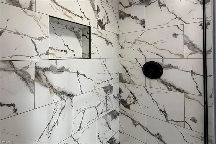 Bathroom view of a marble finish shower