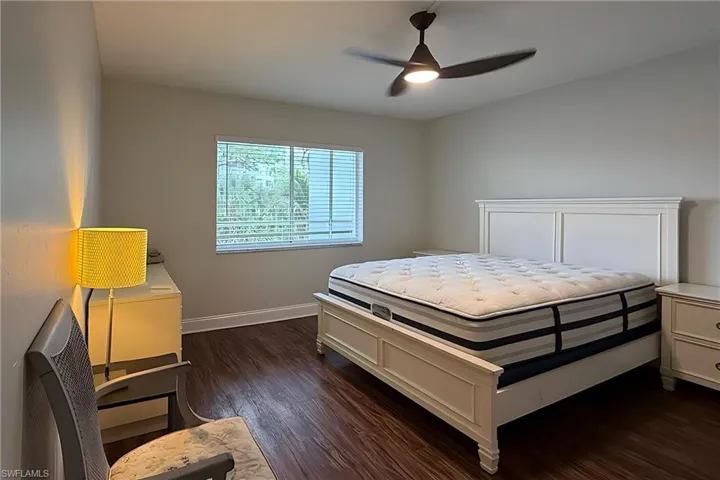 Bedroom featuring dark wood-style floors and ceiling fan