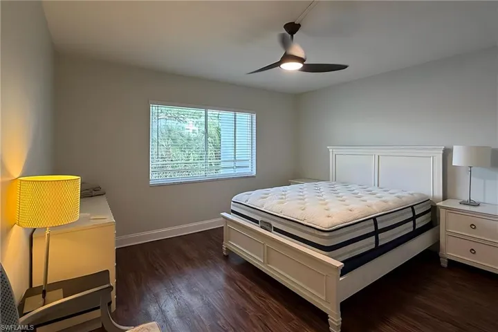 Bedroom featuring dark wood-type flooring and ceiling fan