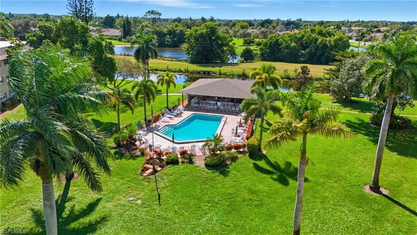 Bird's eye view of a pool and a nearby body of water