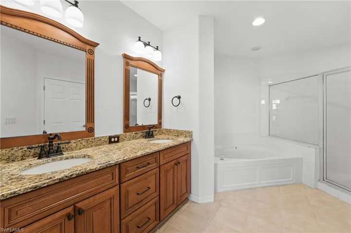 Your primary bath offers dual granite countertop vanities, soaking tub and a walk in shower.