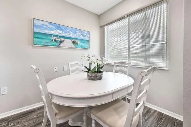 Dining room with baseboards and dark wood finished floors