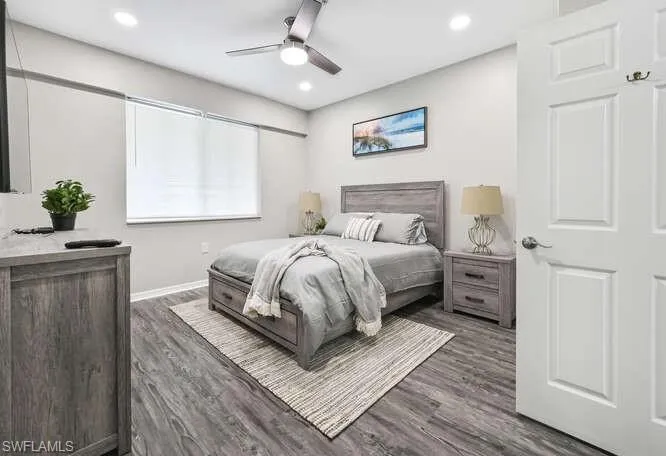 Bedroom with dark wood-style floors, ceiling fan, and recessed lighting