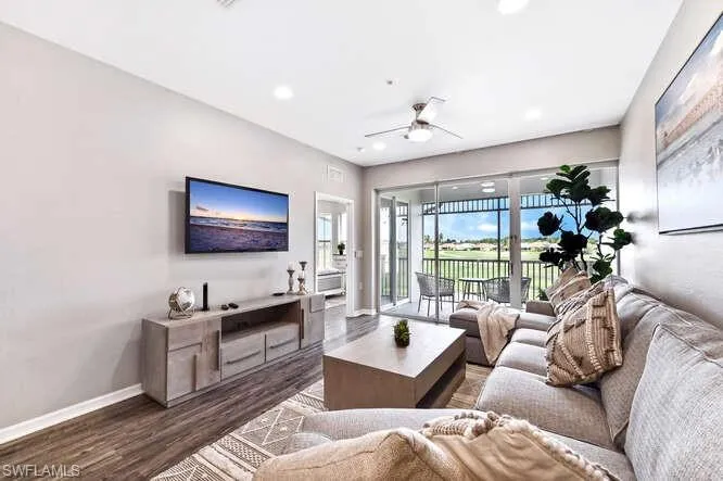 Living area with wood finished floors, a ceiling fan, and recessed lighting