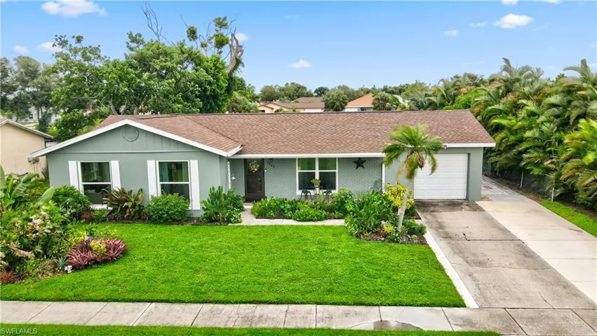 Ranch-style home with a garage and a front yard